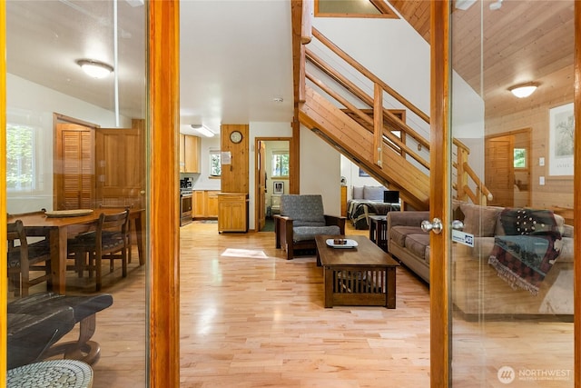 7502 Glacier Spgs, Deming, WA 98244 - living room with stairway, light wood finished floors, healthy amount of natural light, and high vaulted ceiling