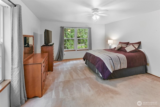 bedroom featuring ceiling fan and light carpet