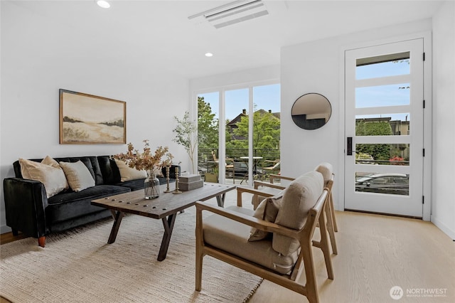 living area with visible vents, recessed lighting, and light wood finished floors