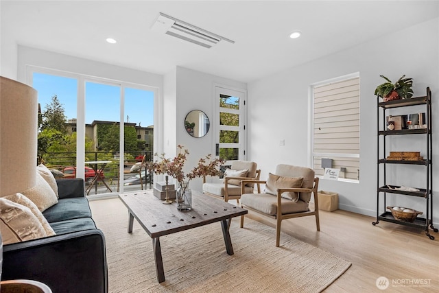 living room with recessed lighting and light wood-style floors