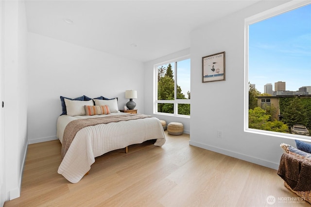 bedroom featuring baseboards and wood finished floors