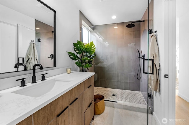bathroom featuring vanity, recessed lighting, and tiled shower
