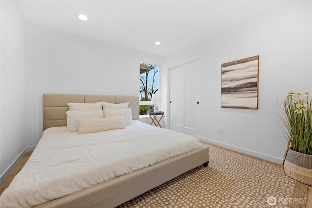 bedroom with baseboards, a closet, and recessed lighting