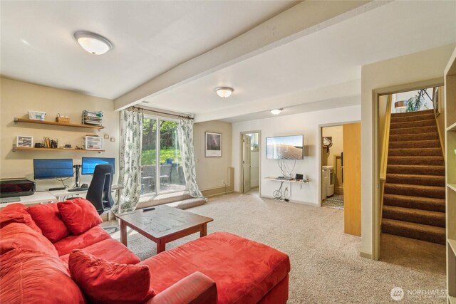 carpeted living room with baseboards, stairs, and beam ceiling