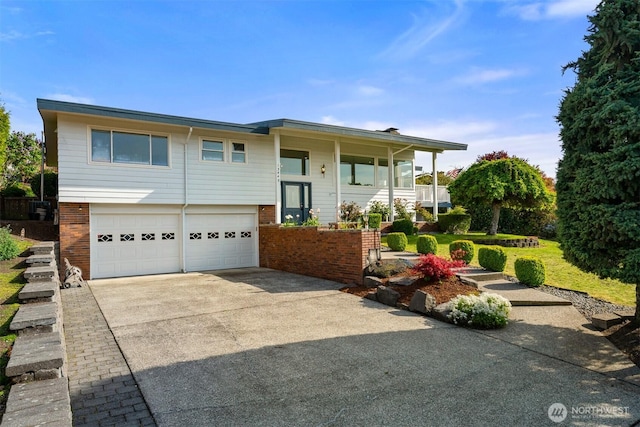 13445 SE 43rd St, Bellevue, WA 98006 - split foyer home featuring concrete driveway, brick siding, and an attached garage