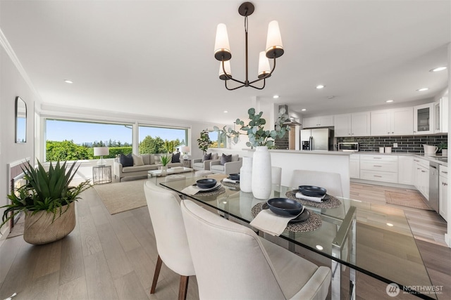 13445 SE 43rd St, Bellevue, WA 98006 - dining area featuring light wood-style floors, recessed lighting, a chandelier, and ornamental molding