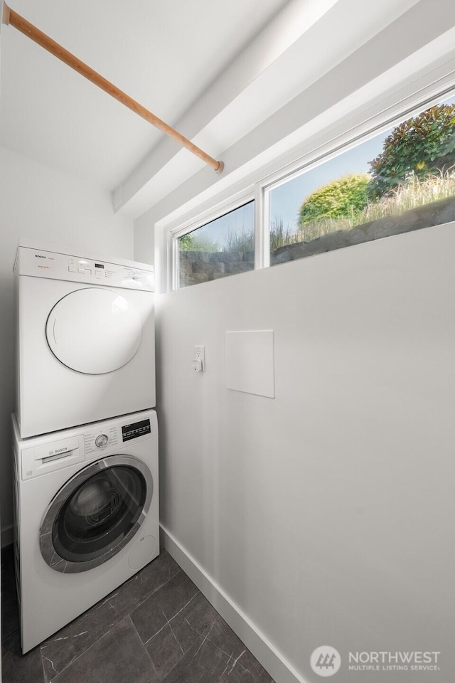 13445 SE 43rd St, Bellevue, WA 98006 - laundry room with laundry area, stacked washing maching and dryer, and baseboards
