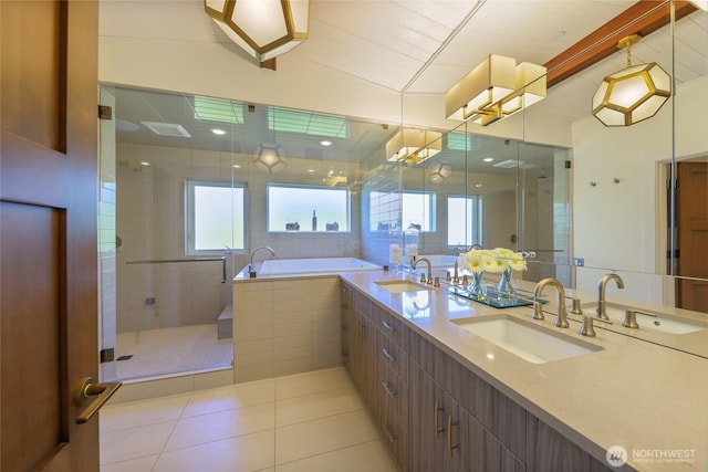 bathroom featuring a shower stall, tile patterned flooring, and a sink