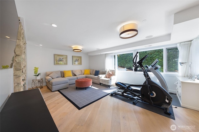 workout room featuring baseboards and wood finished floors