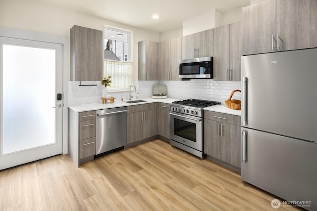 2612A SW Nevada St, Seattle, WA 98126 - kitchen featuring appliances with stainless steel finishes, a sink, light countertops, backsplash, and recessed lighting