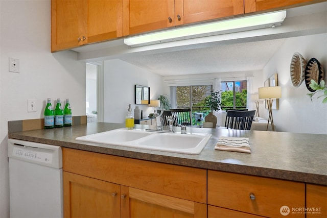 275 W Roy St Unit 216, Seattle, WA 98119 - kitchen with brown cabinets, white dishwasher, dark countertops, and a sink