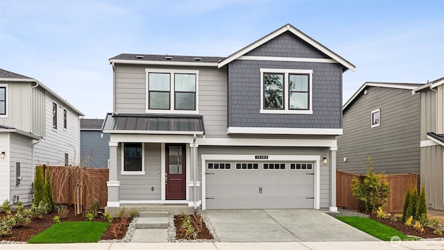 view of front of house featuring fence, driveway, and a garage