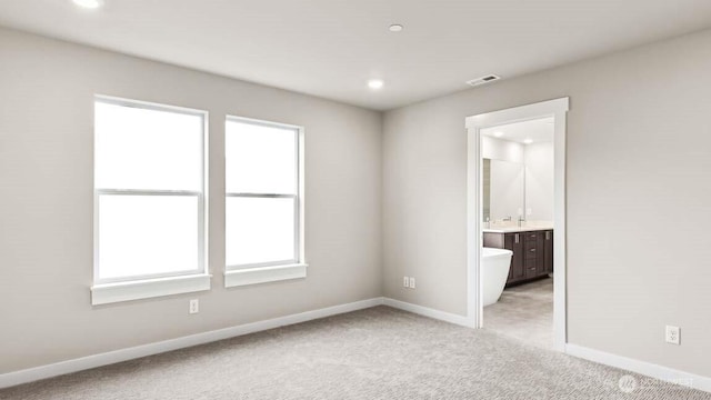 unfurnished bedroom with recessed lighting, baseboards, visible vents, and light carpet