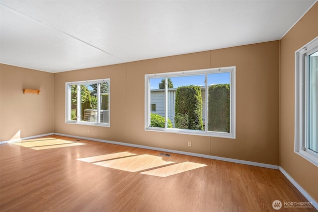 1402 22nd St NE Unit 65, Auburn, WA 98002 - unfurnished room featuring wood finished floors and baseboards