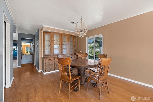 1402 22nd St NE Unit 65, Auburn, WA 98002 - dining area featuring a chandelier, wood finished floors, and baseboards