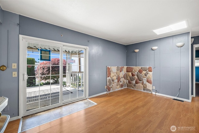 1402 22nd St NE Unit 65, Auburn, WA 98002 - doorway to outside featuring a skylight, wood finished floors, and baseboards