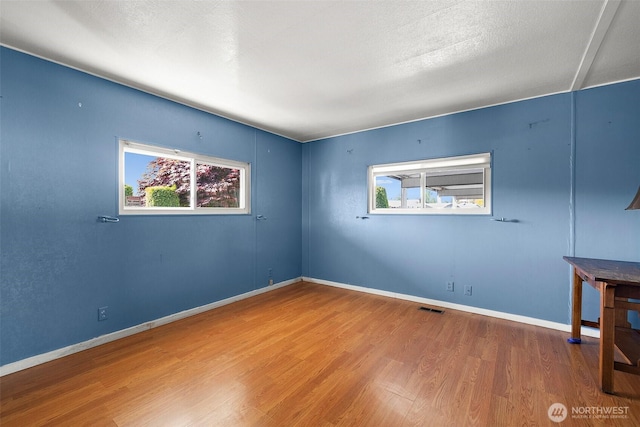 1402 22nd St NE Unit 65, Auburn, WA 98002 - unfurnished room featuring wood finished floors and baseboards