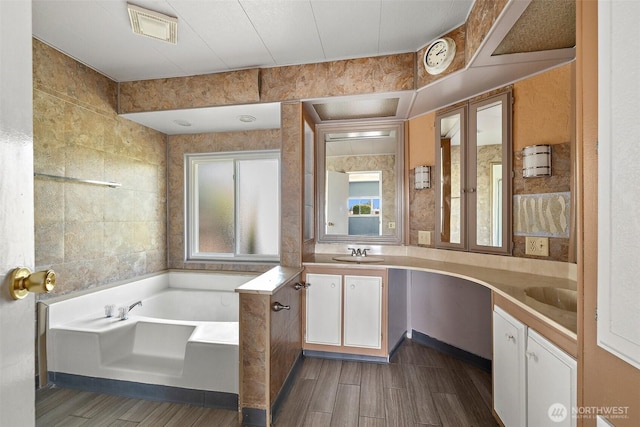 1402 22nd St NE Unit 65, Auburn, WA 98002 - bathroom featuring double vanity, a bath, and wood finished floors
