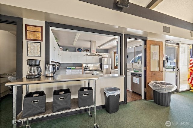 1402 22nd St NE Unit 65, Auburn, WA 98002 - kitchen with island exhaust hood, appliances with stainless steel finishes, white cabinets, carpet floors, and a peninsula