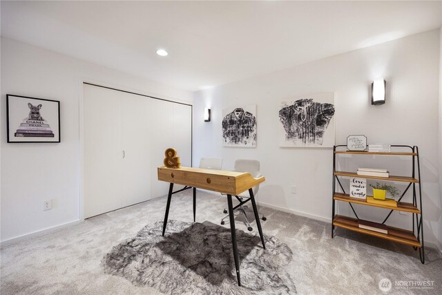 carpeted home office featuring baseboards