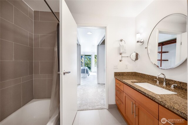 full bath featuring baseboards, shower / bathtub combination with curtain, tile patterned flooring, and vanity
