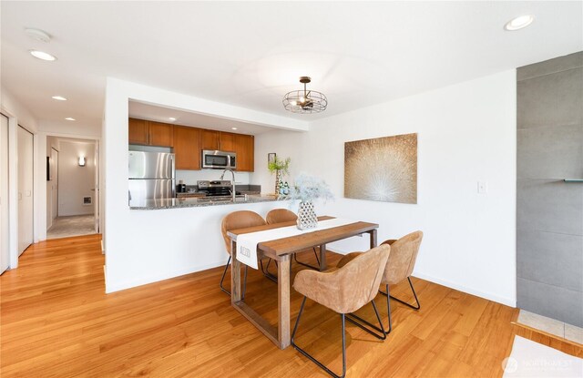 dining area with recessed lighting and light wood-style flooring