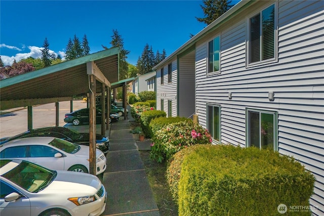 view of property exterior featuring uncovered parking
