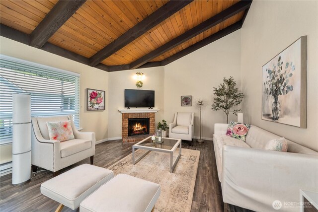 living room with wooden ceiling, lofted ceiling with beams, a brick fireplace, and dark wood-style flooring