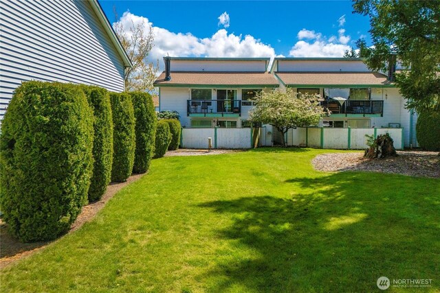 rear view of house with a yard