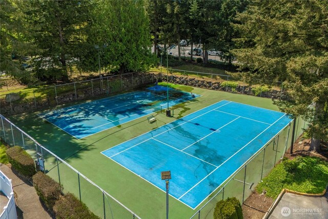 view of tennis court featuring fence