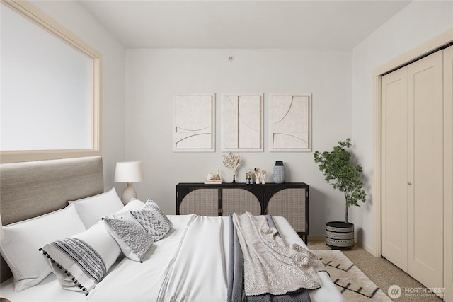 carpeted bedroom featuring a closet