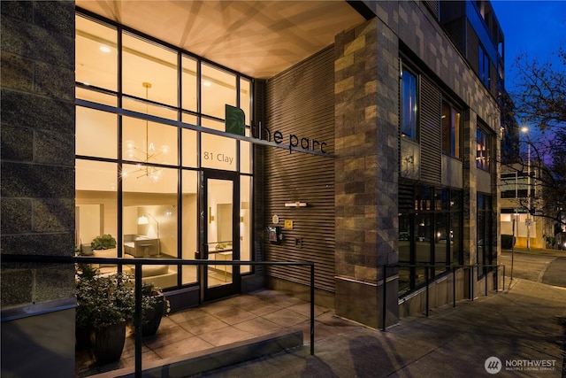 view of exterior entry at night