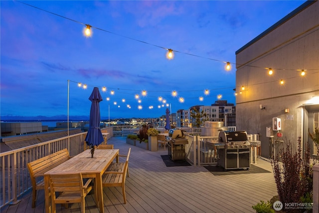 wooden deck featuring area for grilling and outdoor dining space