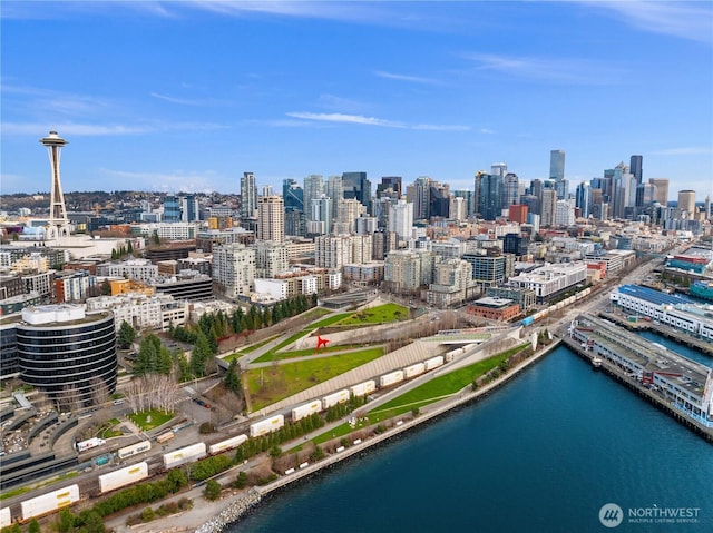 birds eye view of property with a water view and a city view