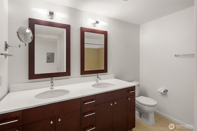 full bath featuring a sink, tile patterned flooring, toilet, and double vanity