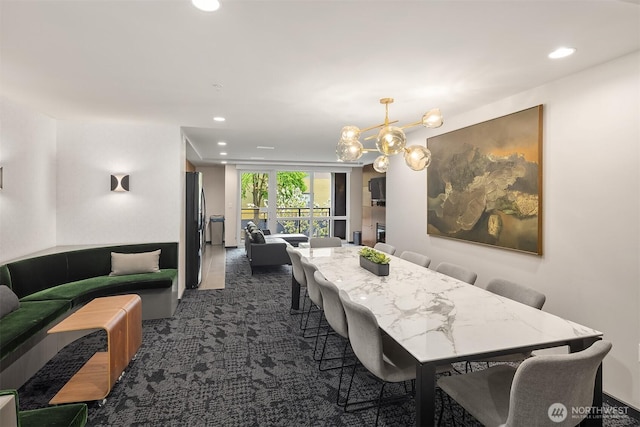 dining room featuring recessed lighting, an inviting chandelier, and dark carpet