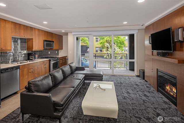 living area with recessed lighting and a glass covered fireplace