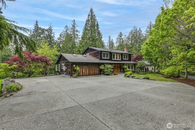 view of front of property with driveway and a chimney