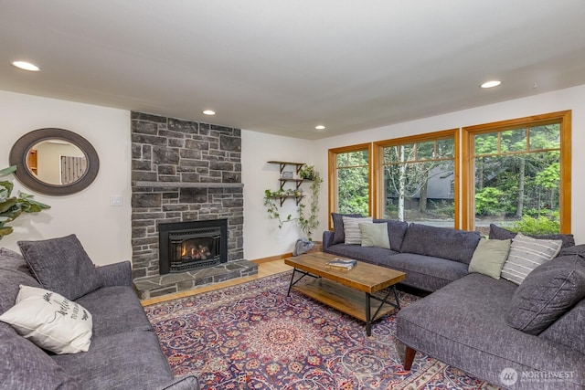 living room with a fireplace, recessed lighting, and wood finished floors
