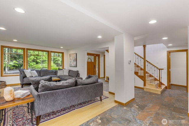 living area featuring baseboards, recessed lighting, and stairs