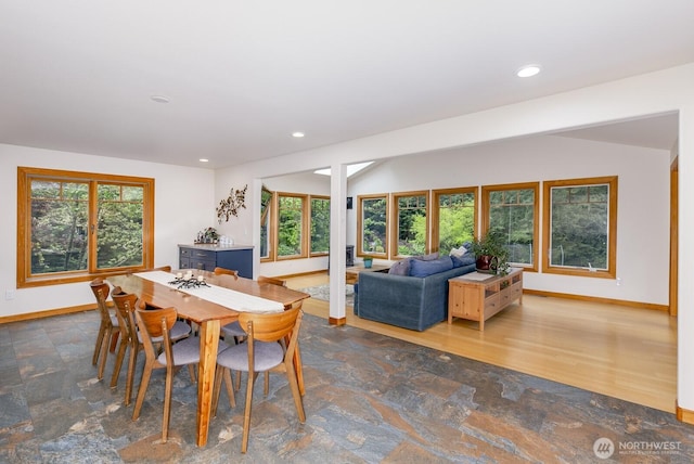 dining space with a healthy amount of sunlight, baseboards, recessed lighting, and stone finish flooring