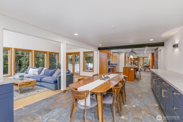 dining area with recessed lighting and stone finish floor