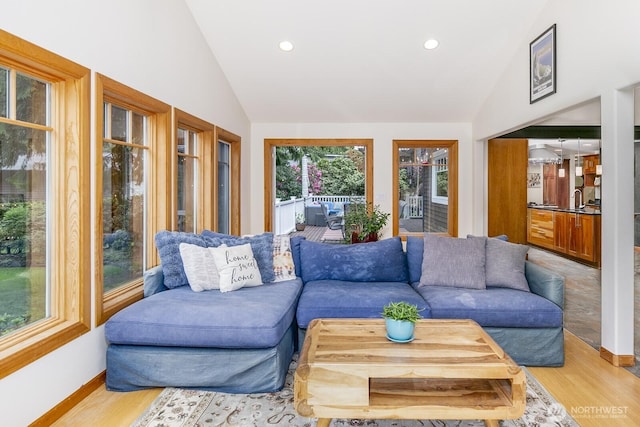 living area with recessed lighting, vaulted ceiling, and wood finished floors