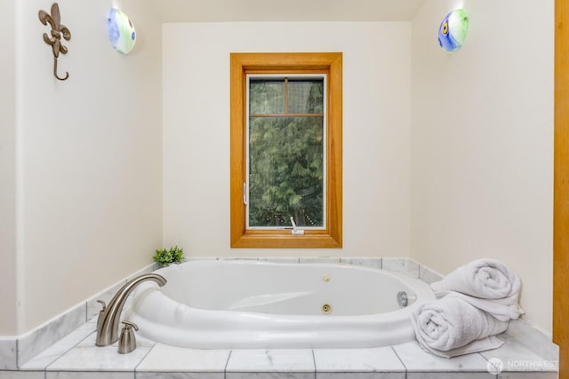 full bath featuring a tub with jets