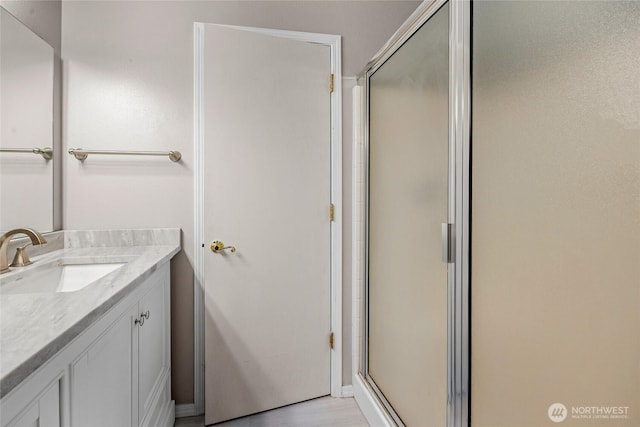 full bath featuring vanity and a stall shower