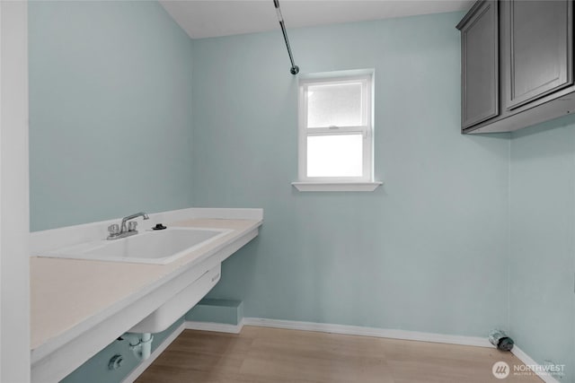 bathroom with baseboards and wood finished floors