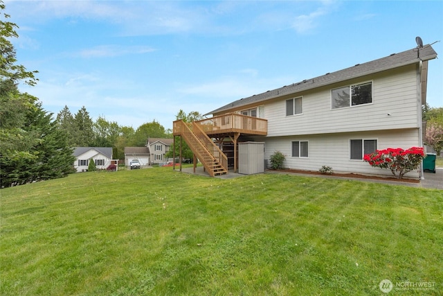 back of house with a wooden deck, stairs, and a yard