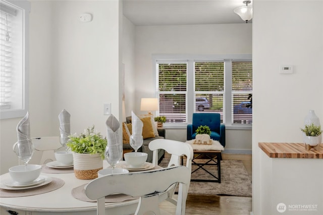 sitting room featuring baseboards and wood finished floors