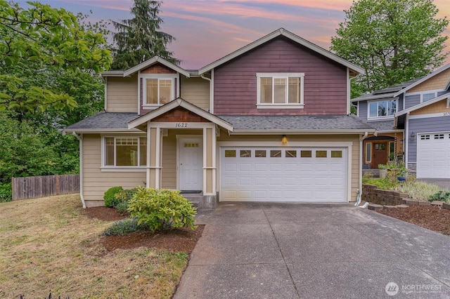 craftsman-style house featuring an attached garage, roof with shingles, fence, and concrete driveway