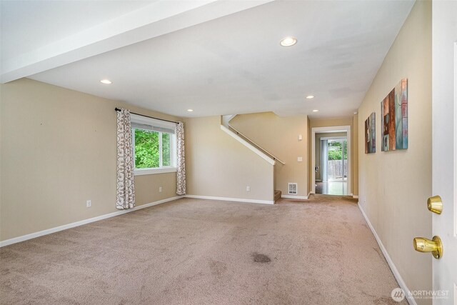 unfurnished living room with carpet floors, visible vents, stairs, baseboards, and recessed lighting